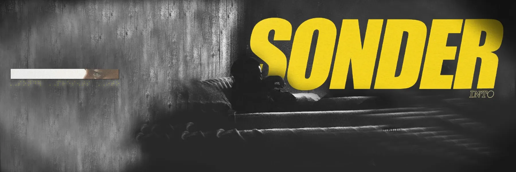Wide black-and-white banner of a smoky room with a figure on a sofa, and SONDER in heavy yellow italic letters on the right.